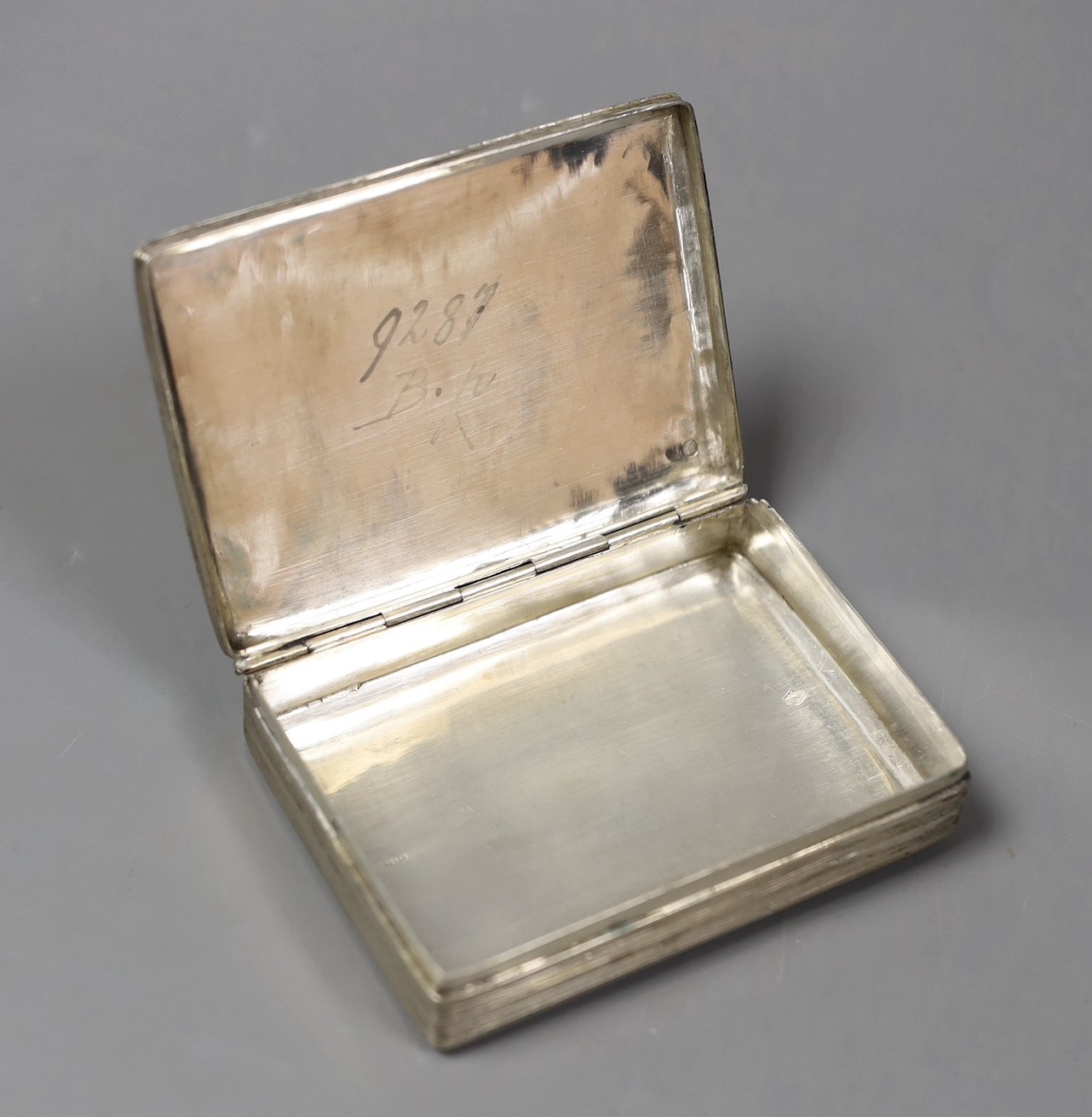 A 19th century Dutch 833 standard white metal rectangular box and hinged cover, engraved with countryside scene, 95mm, 102 grams.